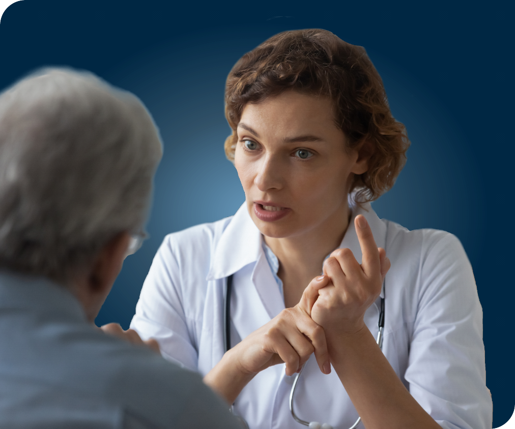 Female healthcare provider talking to elderly patient
